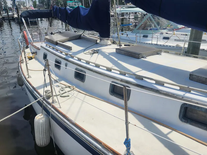 Slide: The Image of 1985 Herreshoff 38 Cat Ketch sailboat docked at a marina. - 8