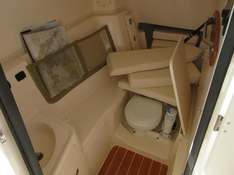Slide: The Image of 2016 Grady-White Freedom 307 boat interior with toilet and storage. - 14