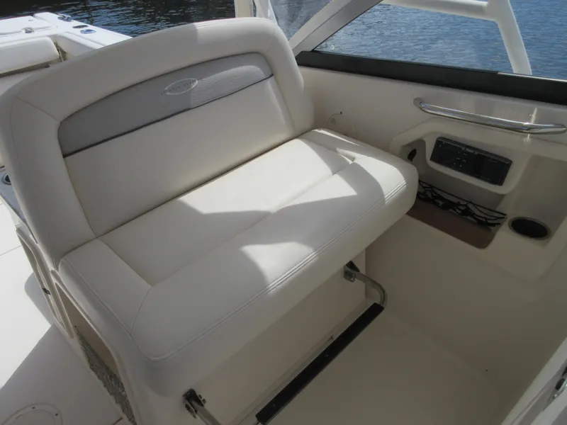 Slide: The Image of 2016 Grady-White Freedom 307 boat interior seating with white upholstery. - 16