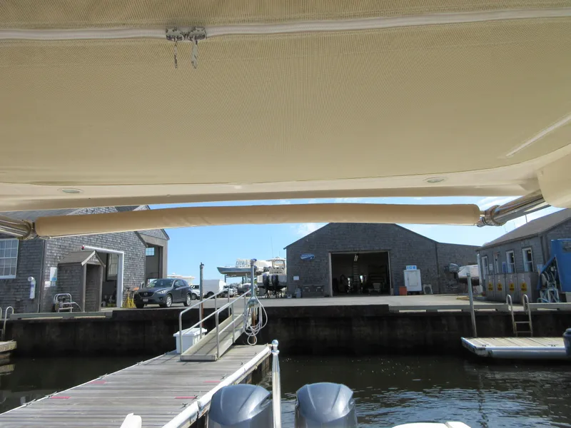 Slide: The Image of 2016 Grady-White Freedom 307 docked at a marina with buildings in the background. - 17