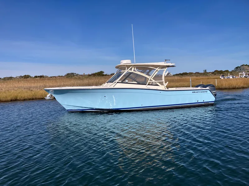 Slide: The Image of 2016 Grady-White Freedom 307 boat on calm water, clear sky background. - 2