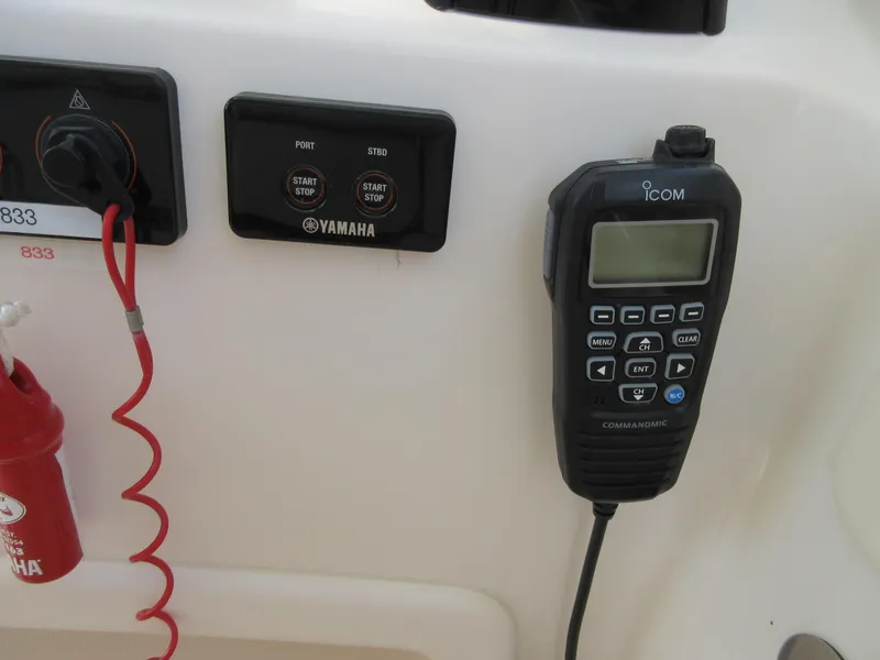 Slide: The Image of ICOM marine radio and Yamaha engine controls on a 2016 Grady-White Freedom 307 boat. - 20