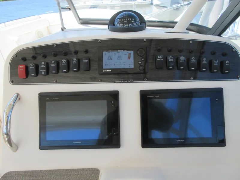 Slide: The Image of Control panel of a 2016 Grady-White Freedom 307 boat with Garmin displays. - 24