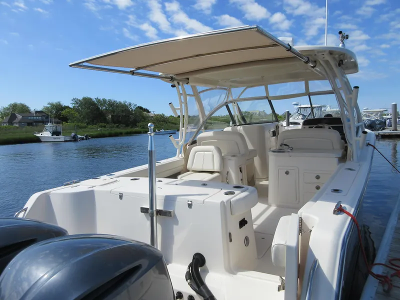 Slide: The Image of 2016 Grady-White Freedom 307 boat docked by a river on a sunny day. - 29