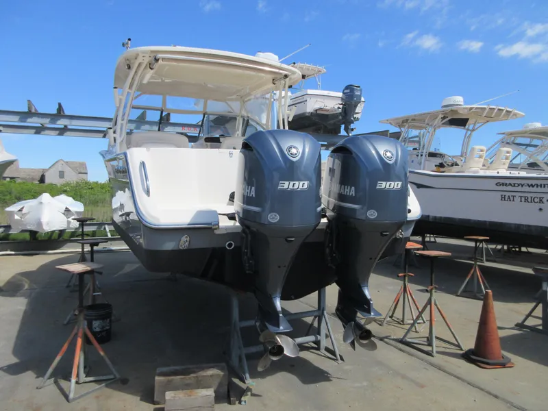 Slide: The Image of 2016 Grady-White Freedom 307 with twin Yamaha 300 engines in a boatyard. - 33