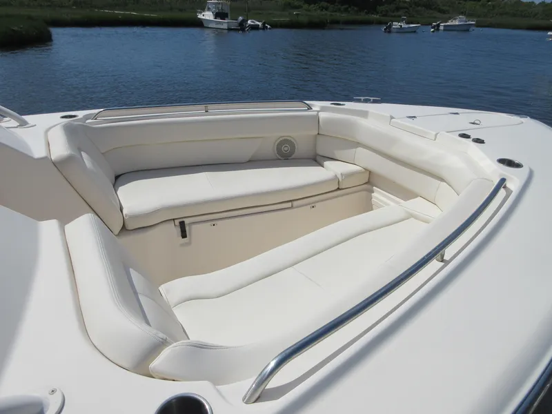 Slide: The Image of 2016 Grady-White Freedom 307 boat with spacious seating area on calm water. - 37