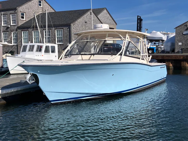 Slide: The Image of 2016 Grady-White Freedom 307 boat docked in a marina, clear blue sky. - 39