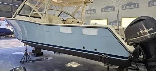 Slide: The Image of 2016 Grady-White Freedom 307 boat in a workshop with Yamaha outboard motor. - 40