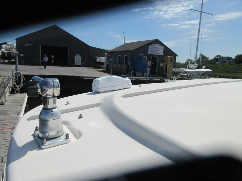 Slide: The Image of 2016 Grady-White Freedom 307 docked at a marina with buildings in the background. - 5