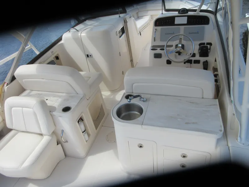 Slide: The Image of 2016 Grady-White Freedom 307 boat interior with helm, seating, and sink. - 6