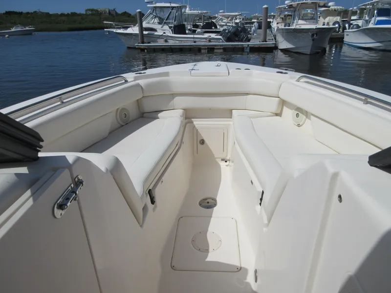 Slide: The Image of 2016 Grady-White Freedom 307 boat interior with white seating, docked at marina. - 9