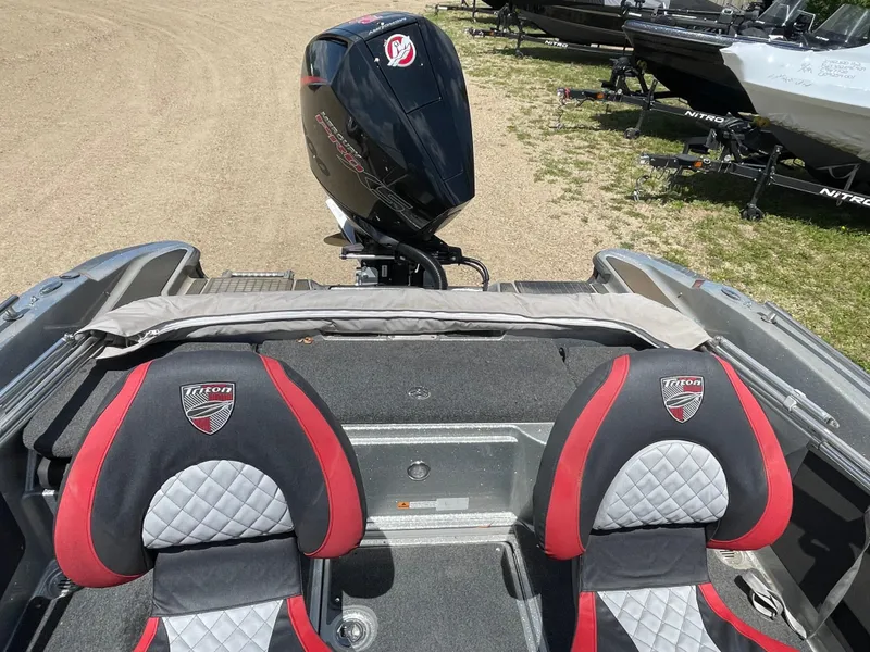 Slide: The Image of 2022 Triton 206 Allure boat with dual seats and outboard motor. - 12