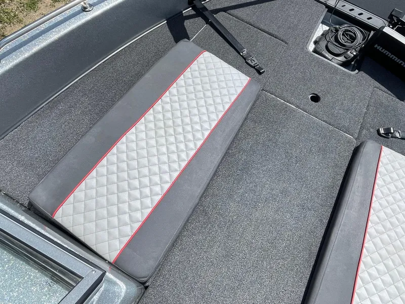 Slide: The Image of 2022 Triton 206 Allure boat interior with quilted seats and carpeted flooring. - 14