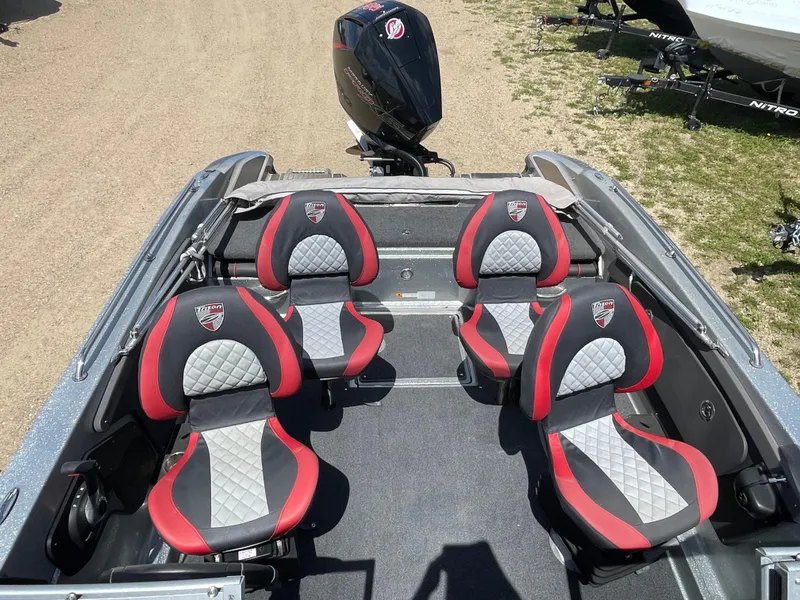 Slide: The Image of 2022 Triton 206 Allure boat with four red and gray seats and an outboard motor. - 18