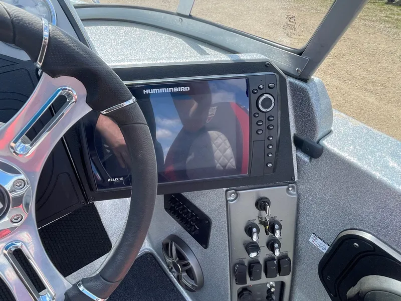 Slide: The Image of 2022 Triton 206 Allure boat dashboard with Humminbird fish finder and steering wheel. - 8