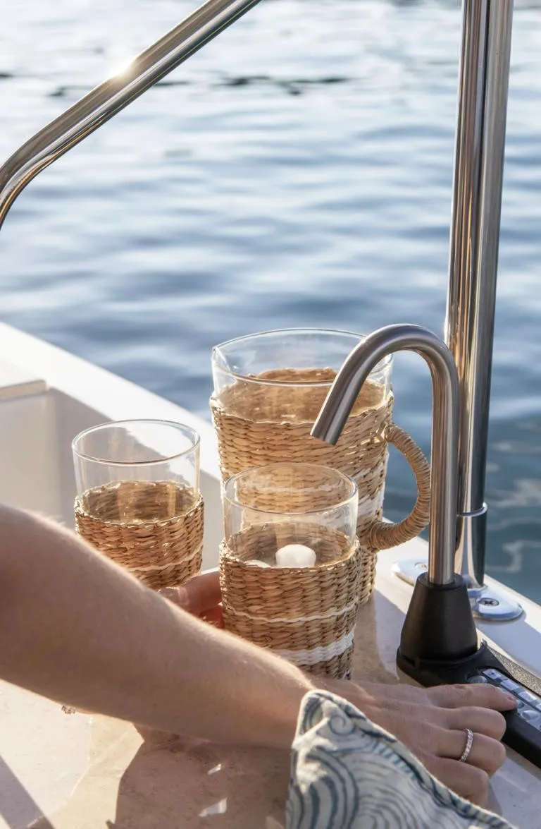 Slide: The Image of Wicker-wrapped glasses on a Duffy Balboa 20' boat, 2026, near water. - 4