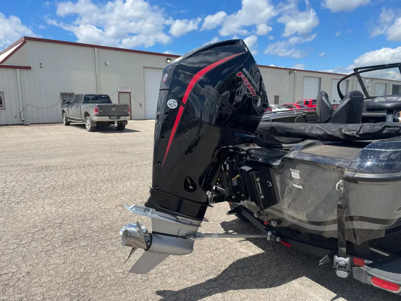 Slide: The Image of 2024 Nitro ZV19 Sport boat with powerful outboard motor in a parking lot. - 4