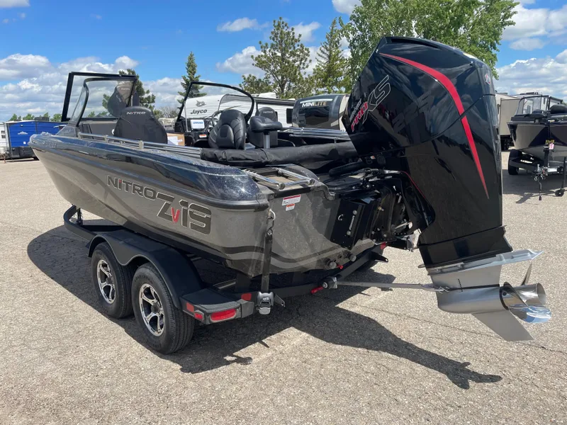 Slide: The Image of 2024 Nitro ZV19 Sport boat with powerful outboard motor in a parking lot. - 5