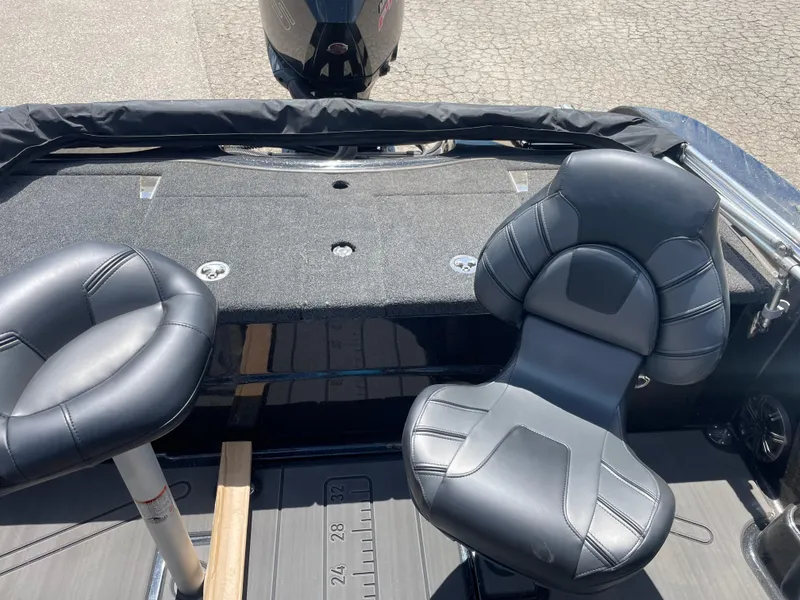 Slide: The Image of 2024 Nitro ZV19 Sport boat interior with two black seats and motor. - 7