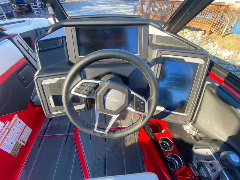 Slide: The Image of 2024 Supra SE boat cockpit with modern steering wheel and touchscreens. - 19