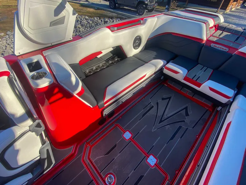 Slide: The Image of 2024 Supra SE boat interior with red and gray seating. - 20