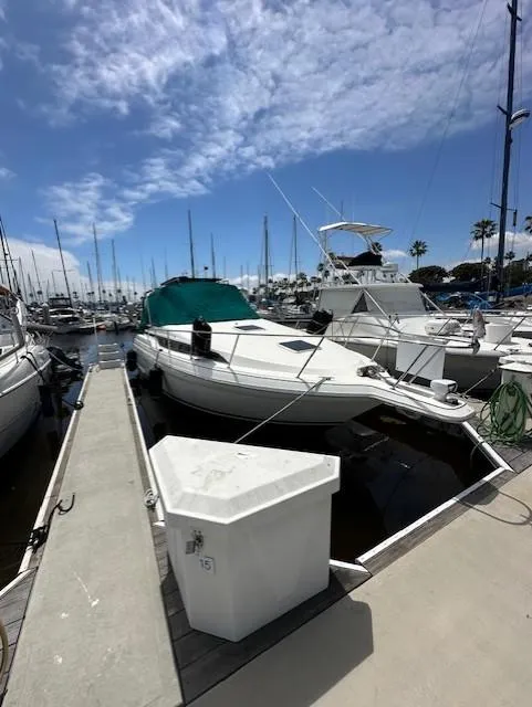 Slide: The Image of 1996 Wellcraft 3200 Martinique docked at marina. - 1