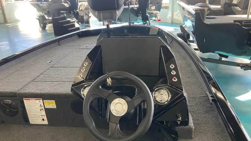 Slide: The Image of 2024 Crestliner XFC 189 boat interior with steering wheel and dashboard controls. - 11