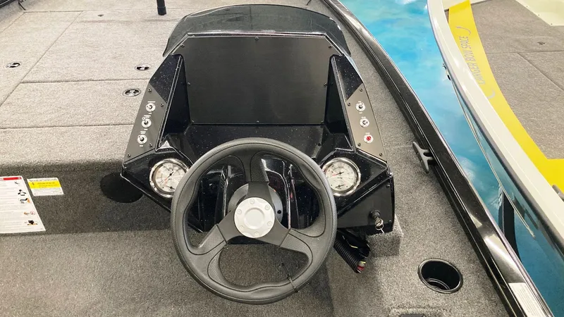 Slide: The Image of 2023 Crestliner XFC 189 boat dashboard with steering wheel and instrument panel. - 12