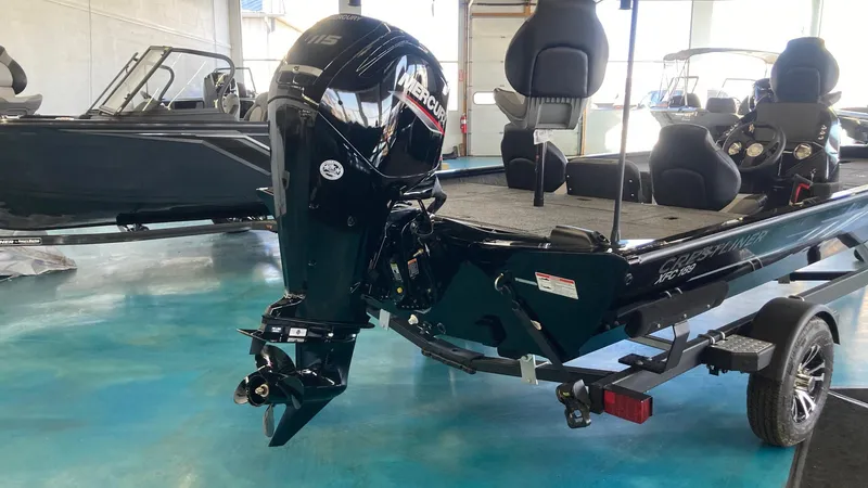 Slide: The Image of 2024 Crestliner XFC 189 boat with Mercury outboard motor in showroom. - 2