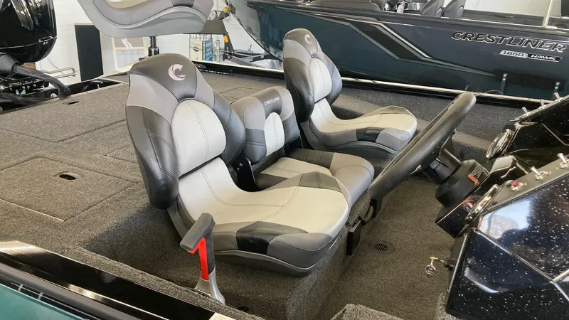 Slide: The Image of 2024 Crestliner XFC 189 boat interior with dual seats and steering console. - 9