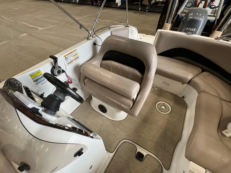 Slide: The Image of 2014 Hurricane SunDeck Sport 202 OB boat interior with steering wheel and seating. - 10