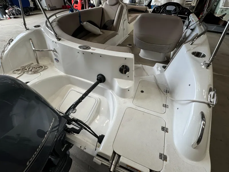 Slide: The Image of 2014 Hurricane SunDeck Sport 202 OB boat interior with seating and storage compartments. - 12