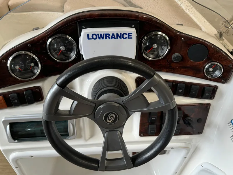 Slide: The Image of 2014 Hurricane SunDeck Sport 202 OB boat dashboard with steering wheel and Lowrance display. - 5