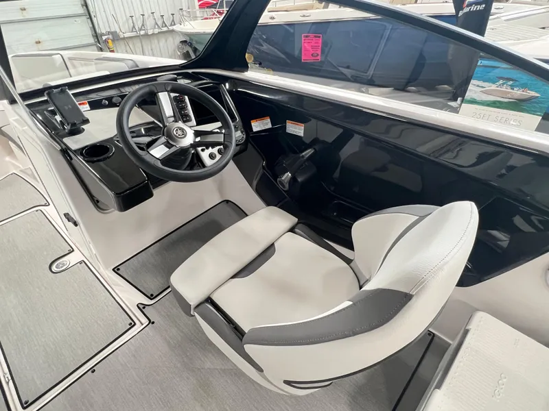Slide: The Image of 2024 Yamaha Boats AR220 cockpit with steering wheel and captain's chair. - 4