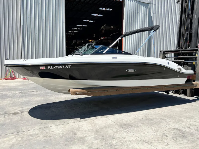 The Image of 2023 Sea Ray SPX 210 boat on forklift outside a warehouse. - 0