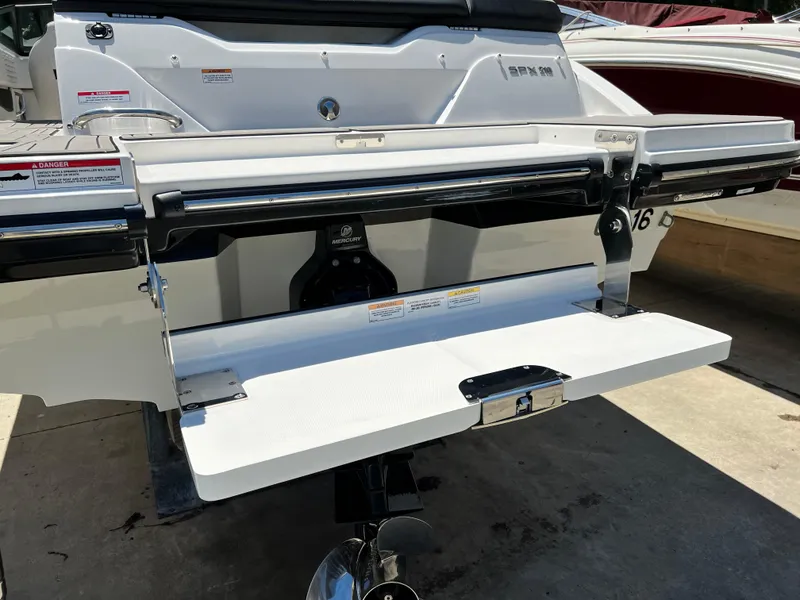 Slide: The Image of 2023 Sea Ray SPX 210 boat stern with swim platform and Mercury engine. - 12