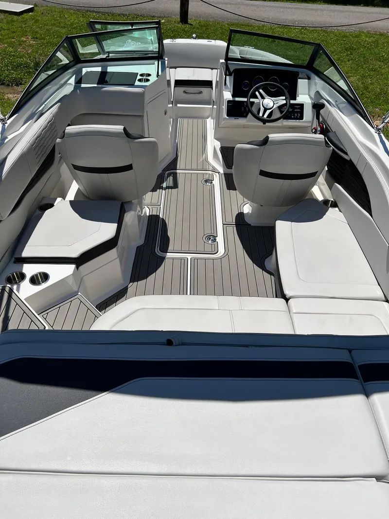Slide: The Image of 2023 Sea Ray SPX 210 boat interior with modern seating and steering console. - 4