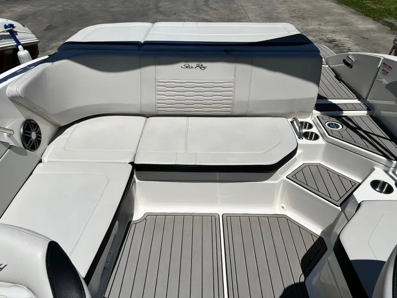 Slide: The Image of 2023 Sea Ray SPX 210 boat interior with white seating and gray flooring. - 9