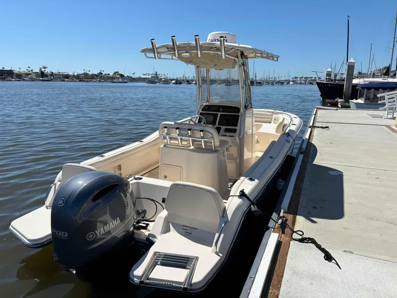 Slide: The Image of 2018 Grady-White Fisherman 216 boat docked, featuring Yamaha engine, clear sky, and calm waters. - 3