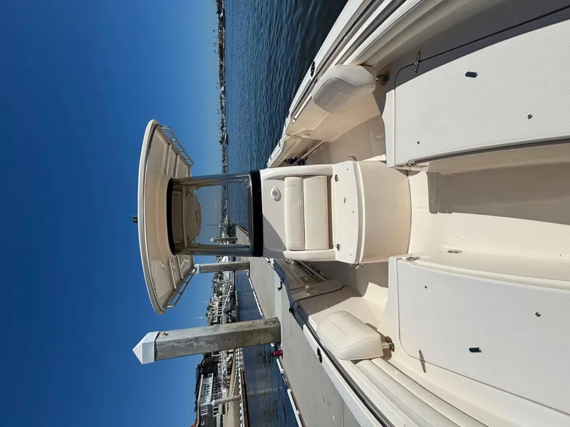 Slide: The Image of 2018 Grady-White Fisherman 216 boat docked at marina under clear blue sky. - 7