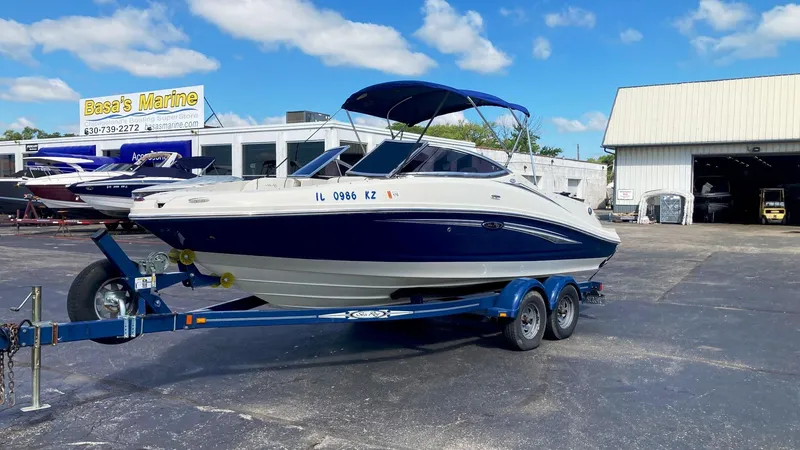 The Image of 2007 Sea Ray 210 Select boat on a trailer at a marine dealership. - 0