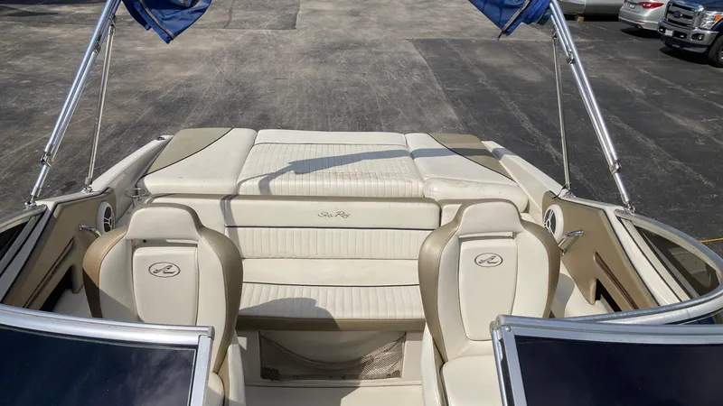 Slide: The Image of 2007 Sea Ray 210 Select boat interior with beige seating and open deck. - 3