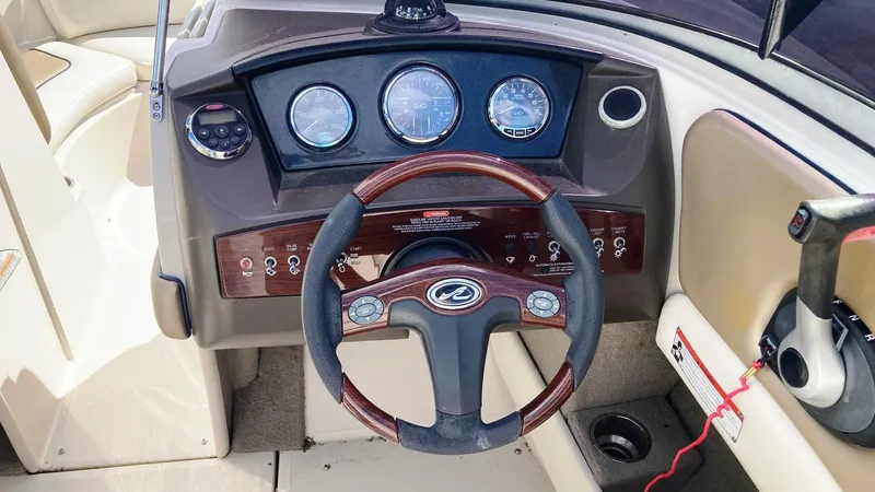 Slide: The Image of 2007 Sea Ray 210 Select boat dashboard with steering wheel and instrument panel. - 6