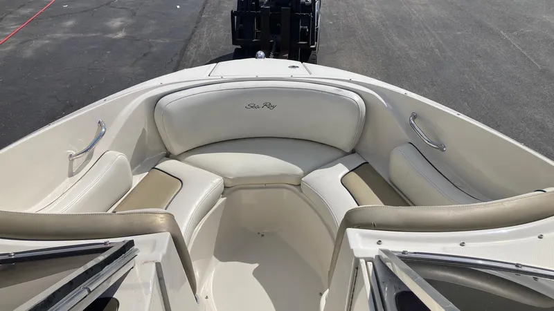Slide: The Image of 2007 Sea Ray 210 Select boat bow seating area with white and beige upholstery. - 8