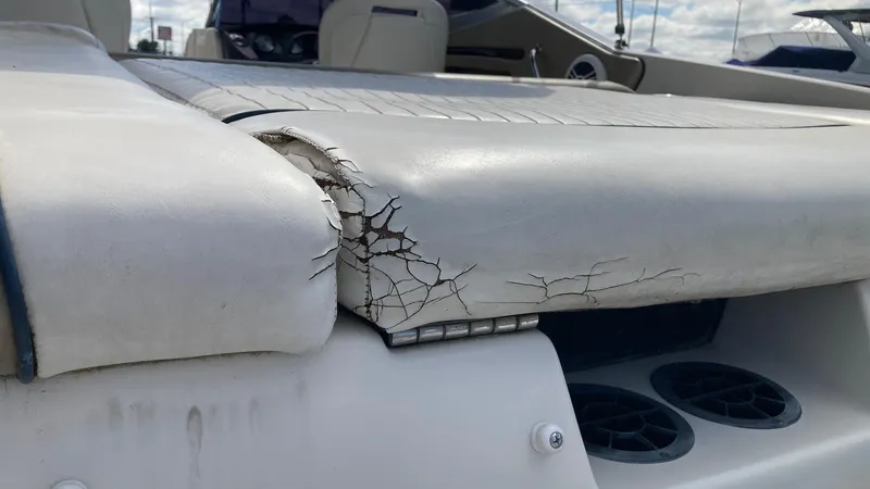 Slide: The Image of 2007 Sea Ray 210 Select boat with cracked and worn upholstery. - 9