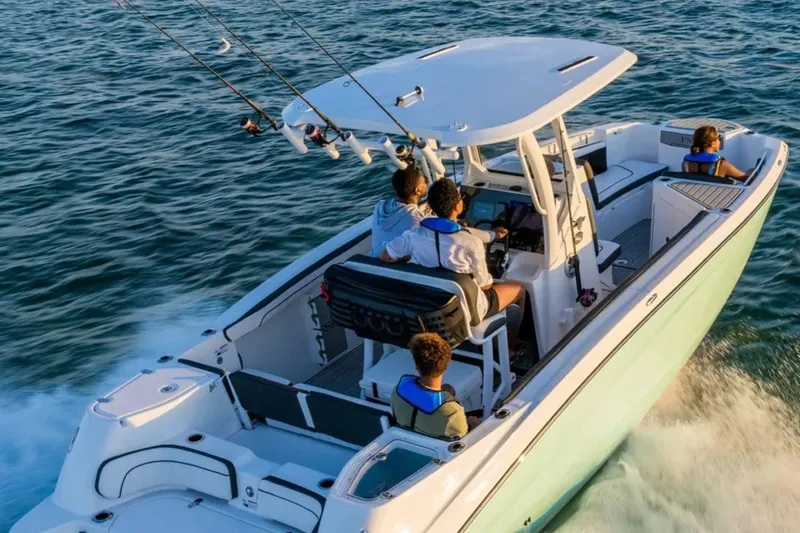 Slide: The Image of 2024 Yamaha Boats 255 FSH Sport E cruising on open water with passengers. - 9