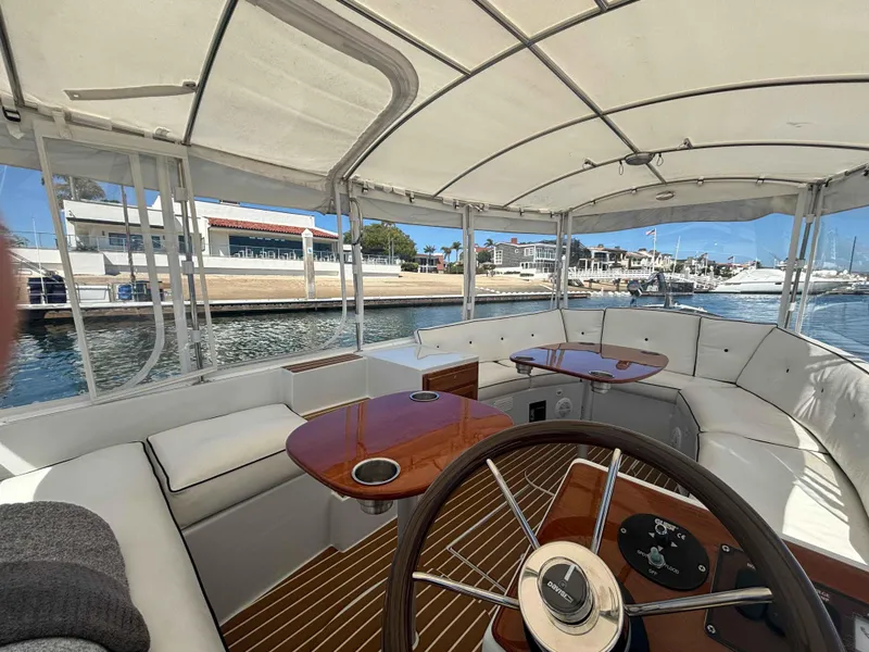 Slide: The Image of Interior of 2013 Duffy Snug Harbor boat with white seating and wooden accents. - 3