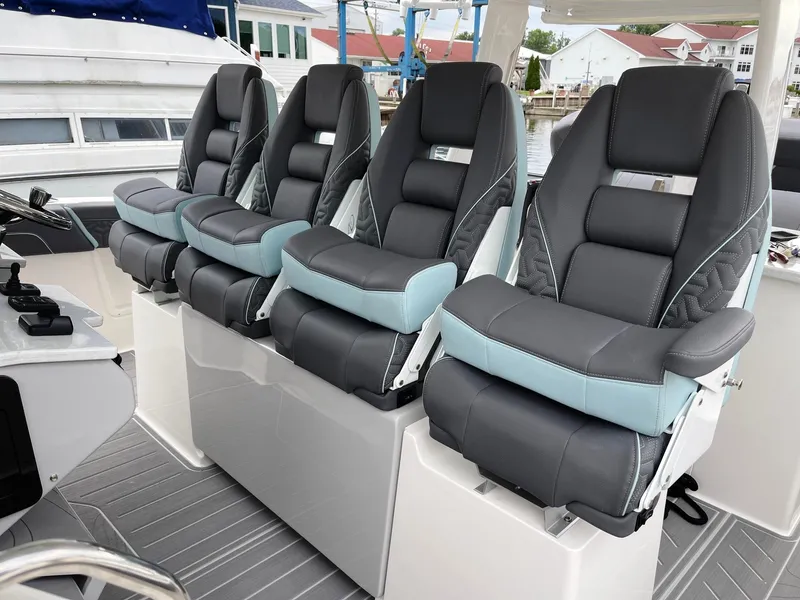 Slide: The Image of Four luxurious captain's chairs on the 2025 Regal 38 SAV boat. - 10