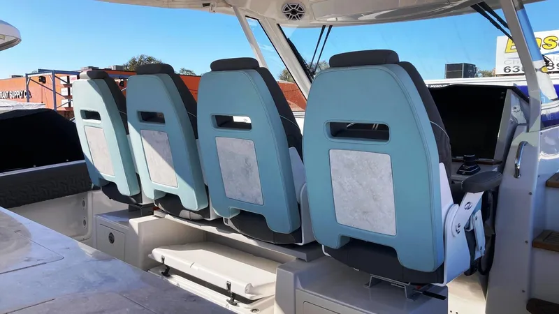 Slide: The Image of 2025 Regal 38 SAV boat interior with four blue seats. - 11