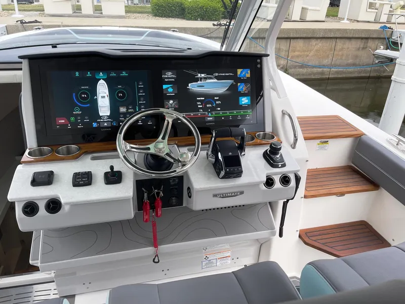 Slide: The Image of 2025 Regal 38 SAV boat dashboard with advanced navigation system and controls. - 13